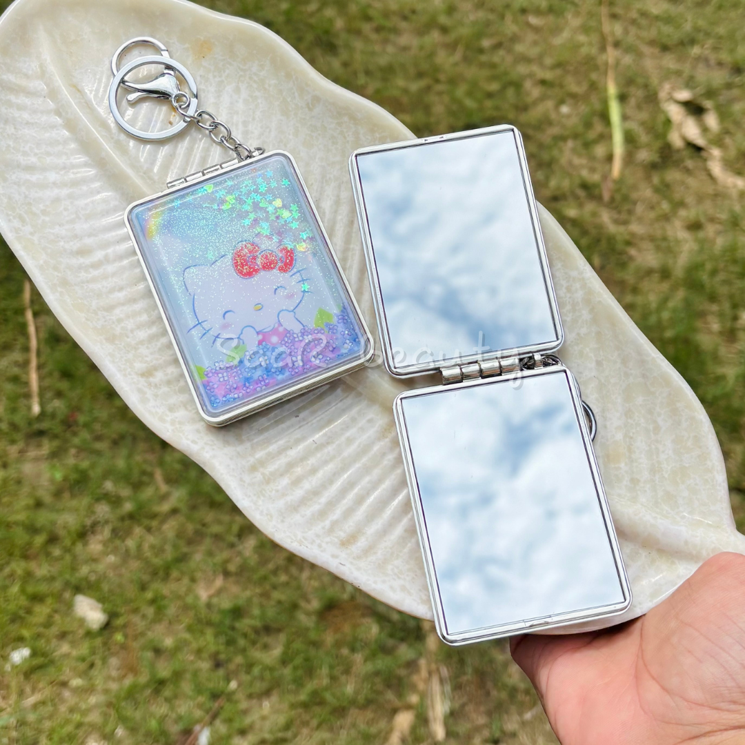 Compact mirror with a cartoon design on a flip-flop against a grassy Portable travel mirror keychain with glitter designbackground