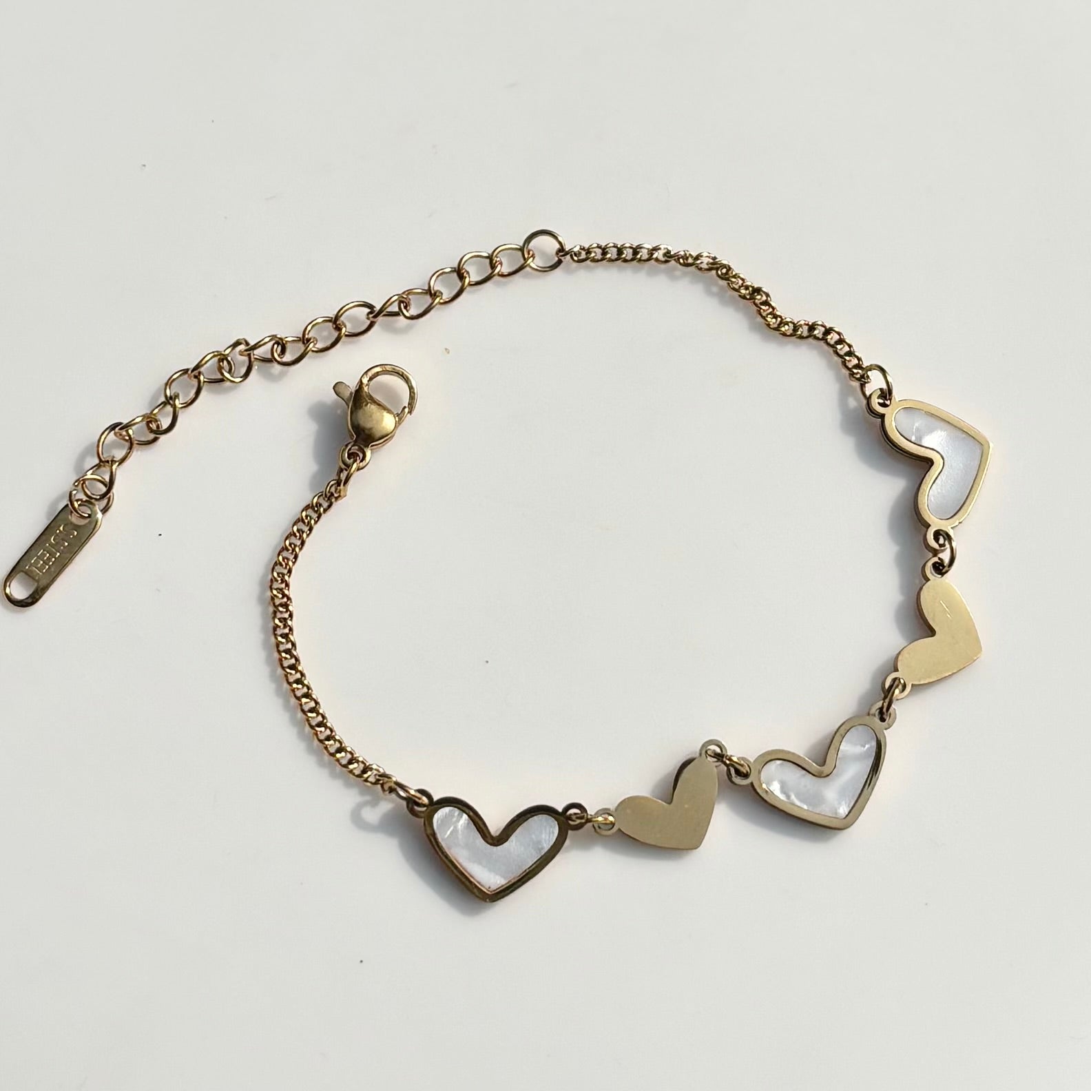 Gold bracelet with heart-shaped links on a light gray background Gold bracelet with heart-shaped links on a marble surface Saar Beauty heart charm gold bracelet for women waterproof jewellery
Anti tarnish heart charm bracelet daily wear fashion jewellery