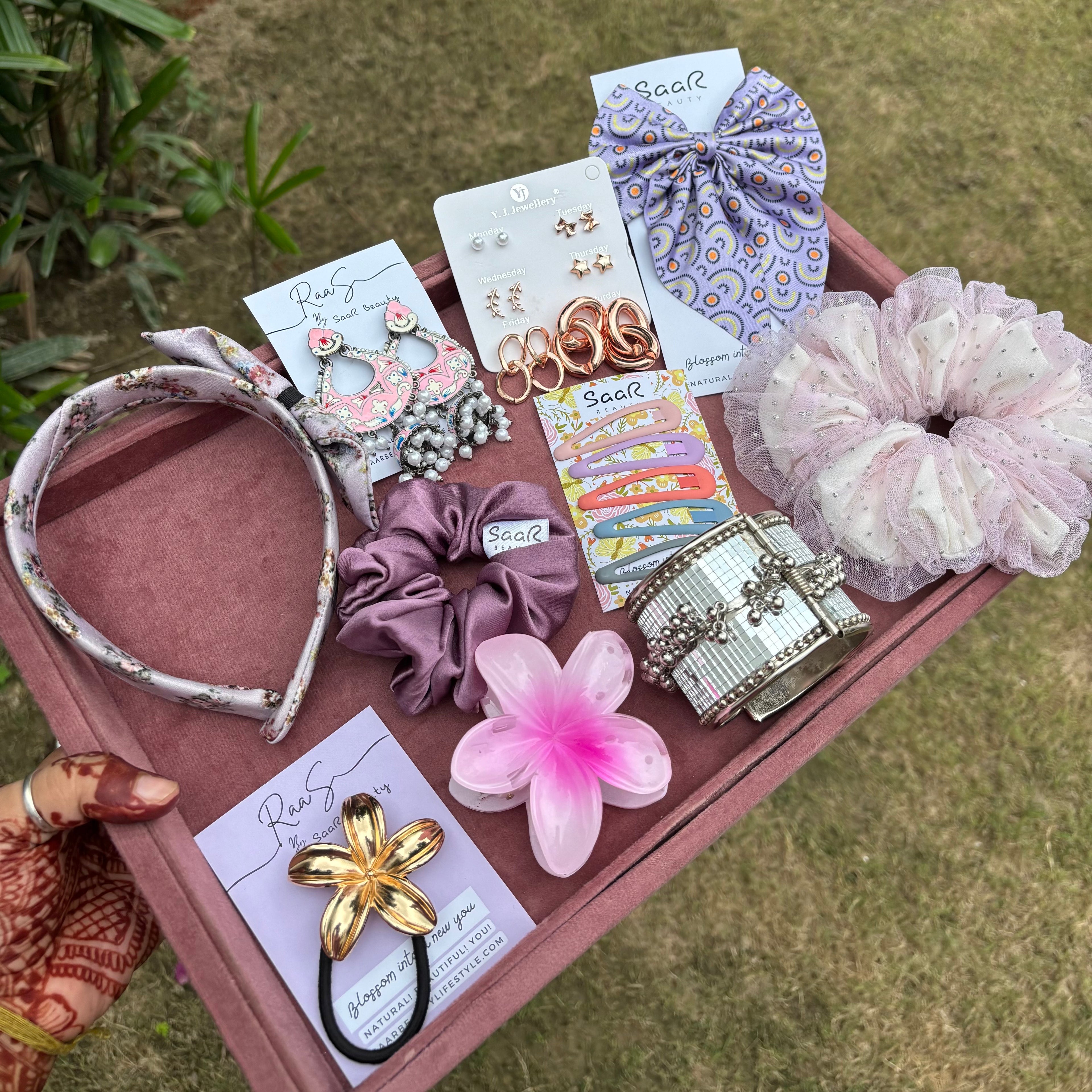 Rakshabandhan Gift Box with jhumka earrings, satin scrunchies, fluffy bow, floral claw clip, satin headband, kada bracelet, and tic tac clips by Saar Beauty.
