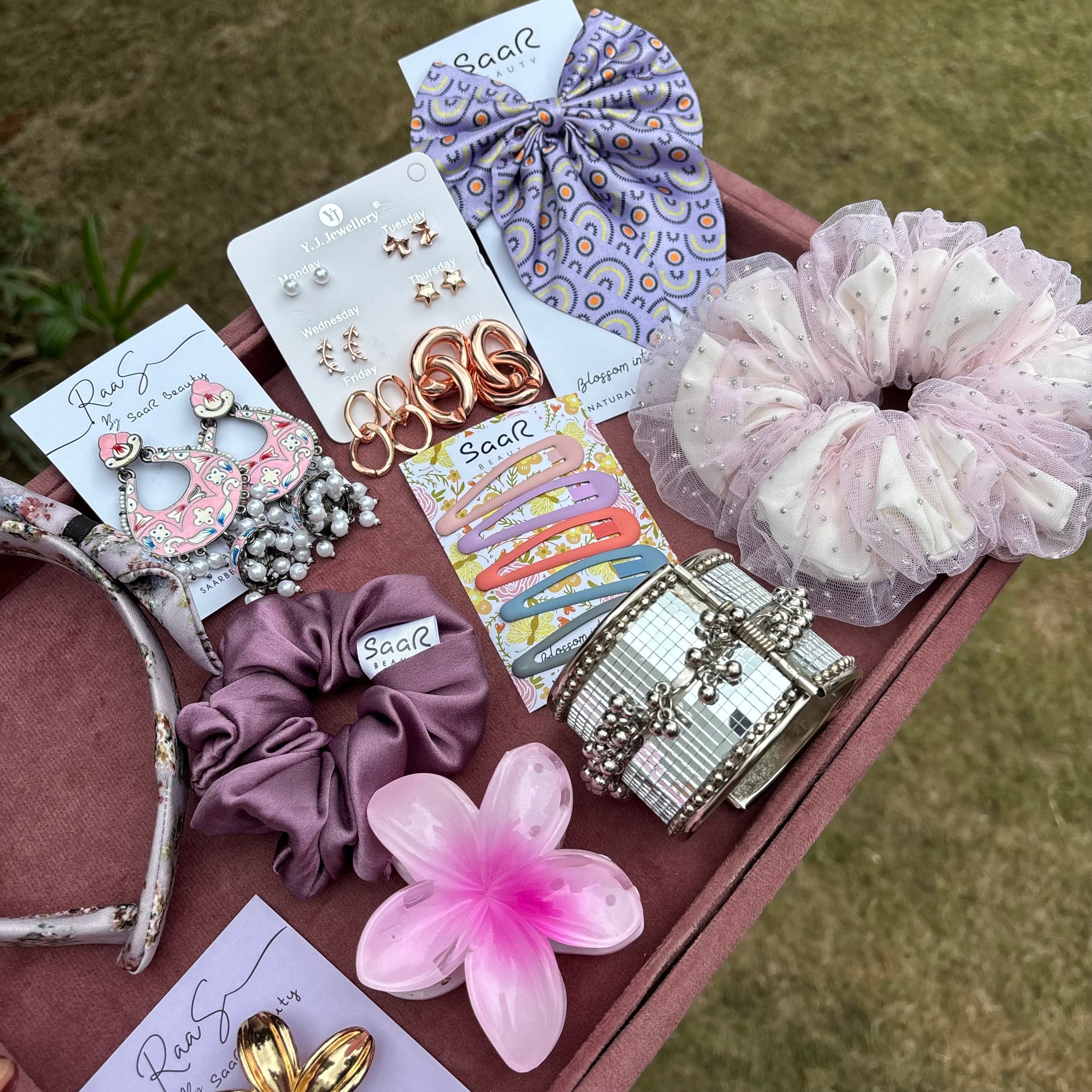 Rakshabandhan Gift Box with jhumka earrings, satin scrunchies, fluffy bow, floral claw clip, satin headband, kada bracelet, and tic tac clips by Saar Beauty.