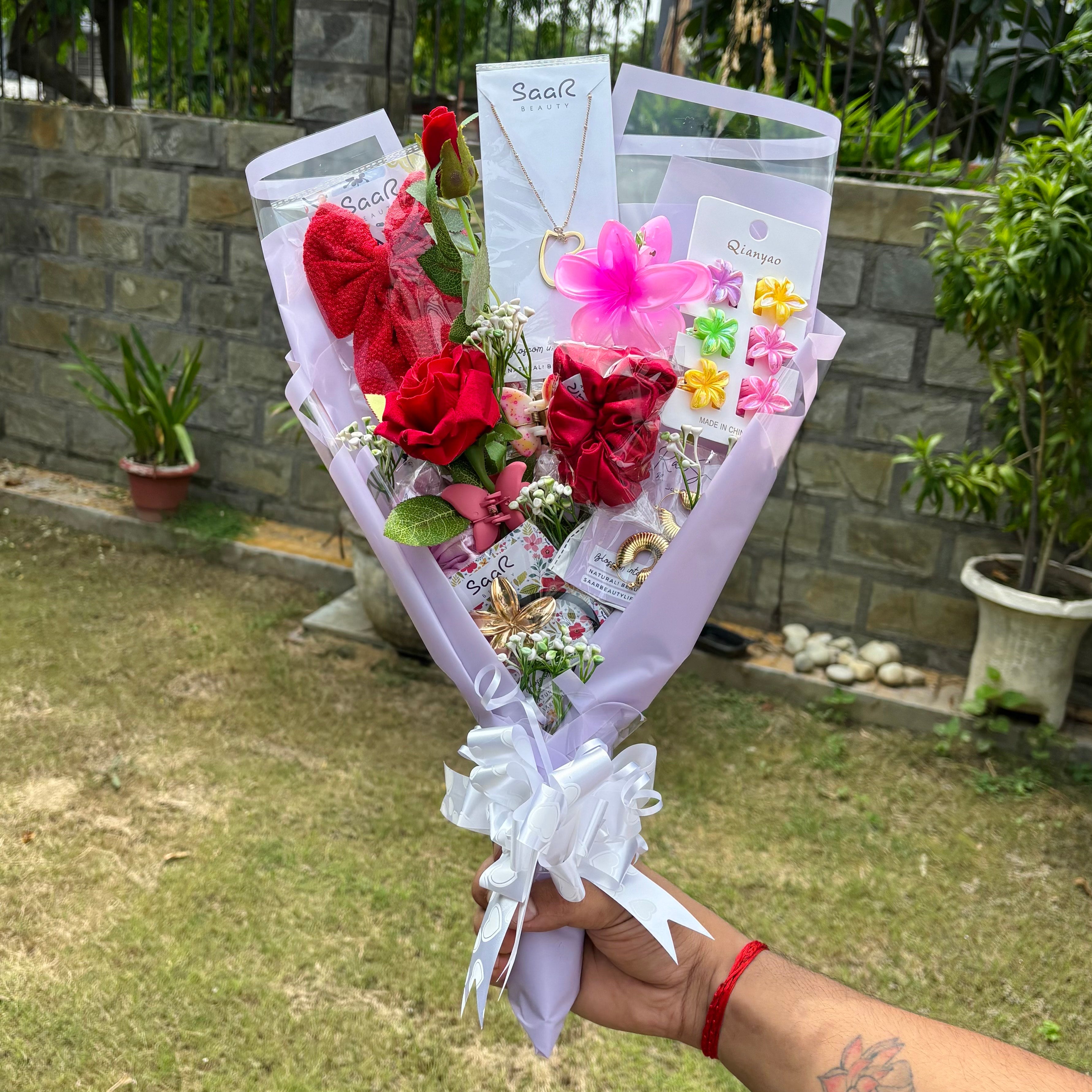 Bouquet of flowers with jewelry and decorative items held outdoors.