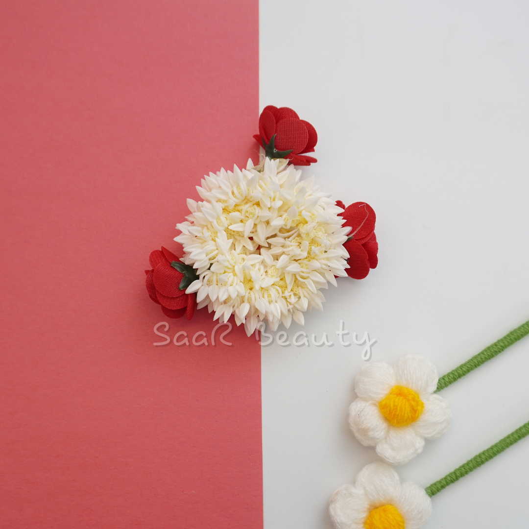 Add elegance to your hairstyle with the White Gajra Scrunchie with Red Roses. Perfect for weddings and festive occasions, this floral accessory blends jasmine and red roses for a striking traditional look.