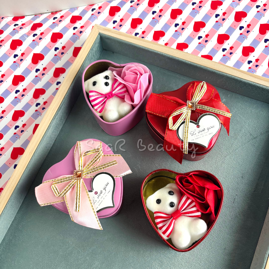 Small heart-shaped gift box with a mini teddy bear, artificial roses, a satin ribbon, and a love tag—perfect romantic gift for special occasions.