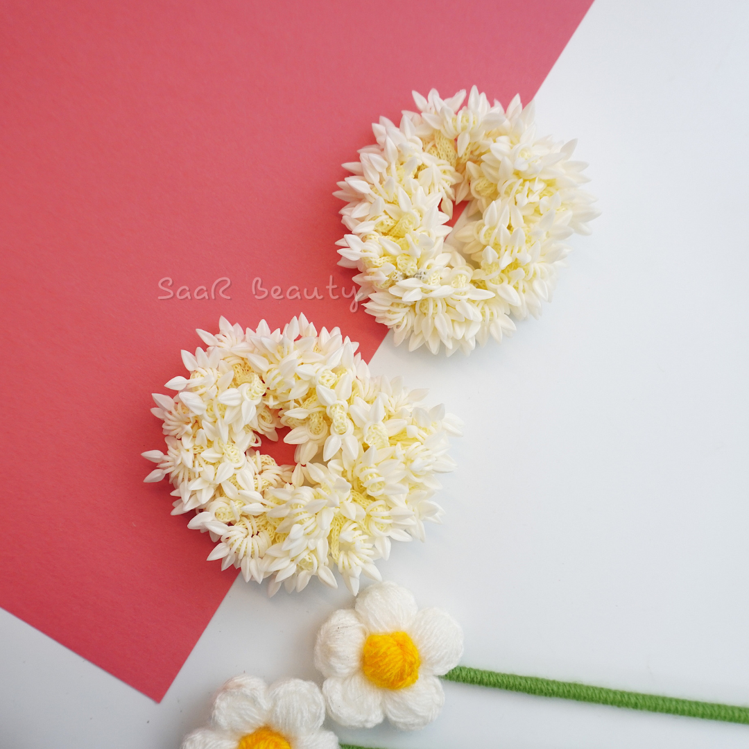 Shop the Traditional Gajra Scrunchie for weddings and festive occasions. This artificial floral accessory offers a realistic jasmine look, perfect for bun hairstyles and bridal ceremonies.