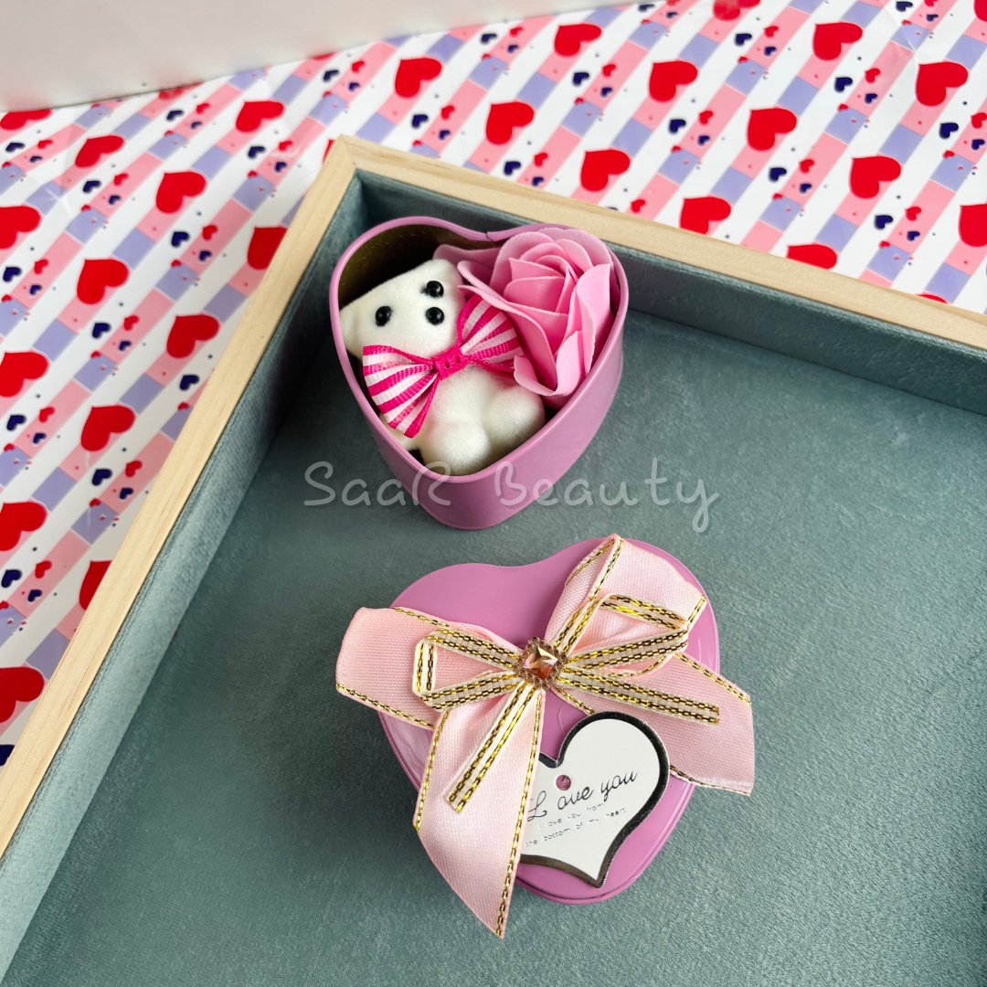 Small heart-shaped gift box with a mini teddy bear, artificial roses, a satin ribbon, and a love tag—perfect romantic gift for special occasions.