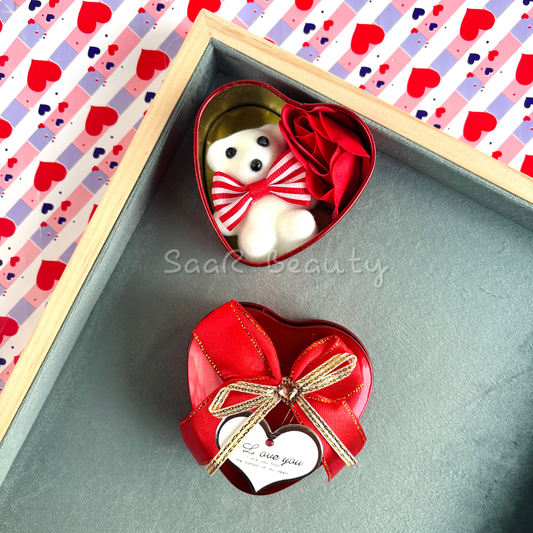 Small heart-shaped gift box with a mini teddy bear, artificial roses, a satin ribbon, and a love tag—perfect romantic gift for special occasions.