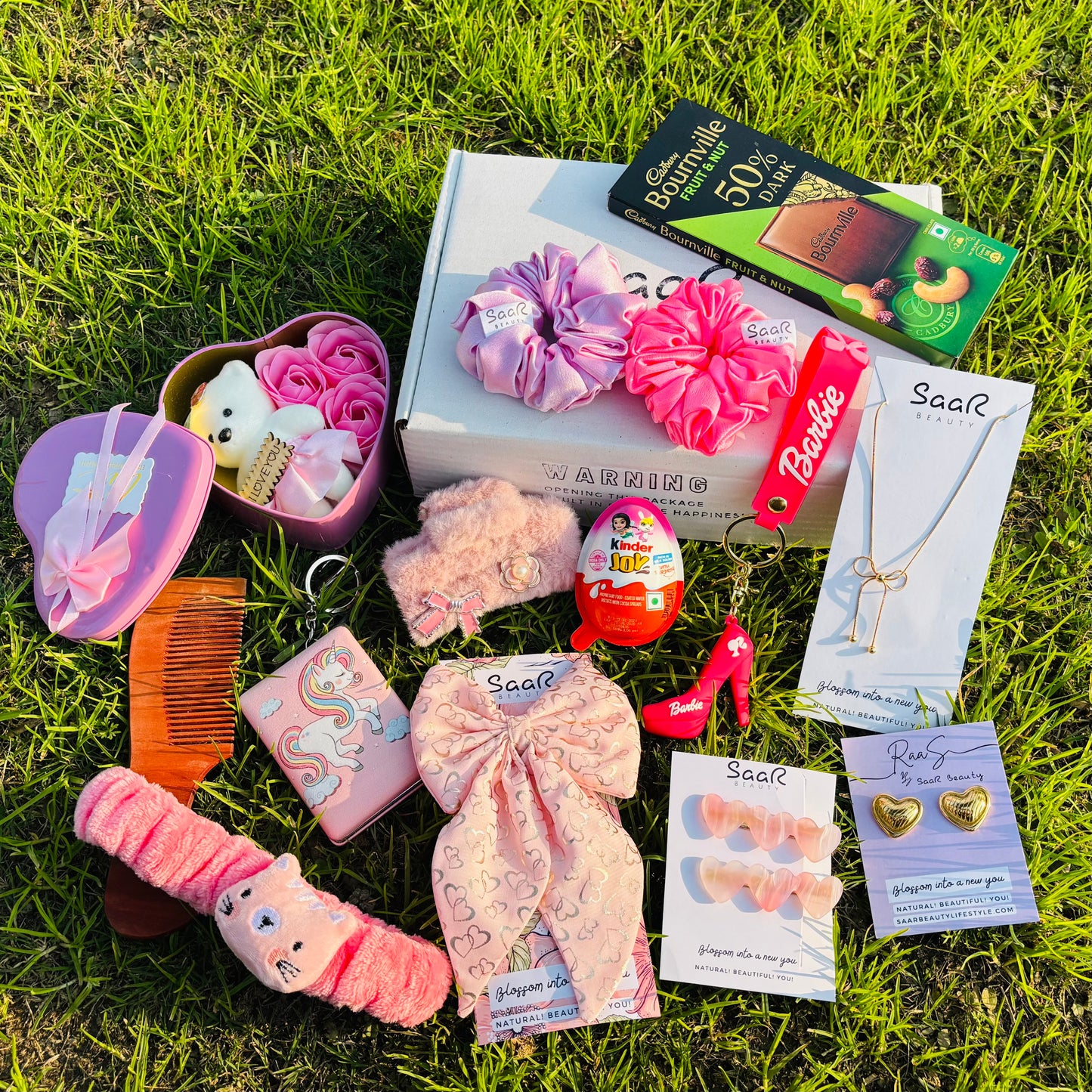 SaaR Beauty Valentine’s Gift Set – A luxury gift box featuring satin scrunchies, a necklace, earrings, chocolates, a plush headband, a heart bow clip, and more.