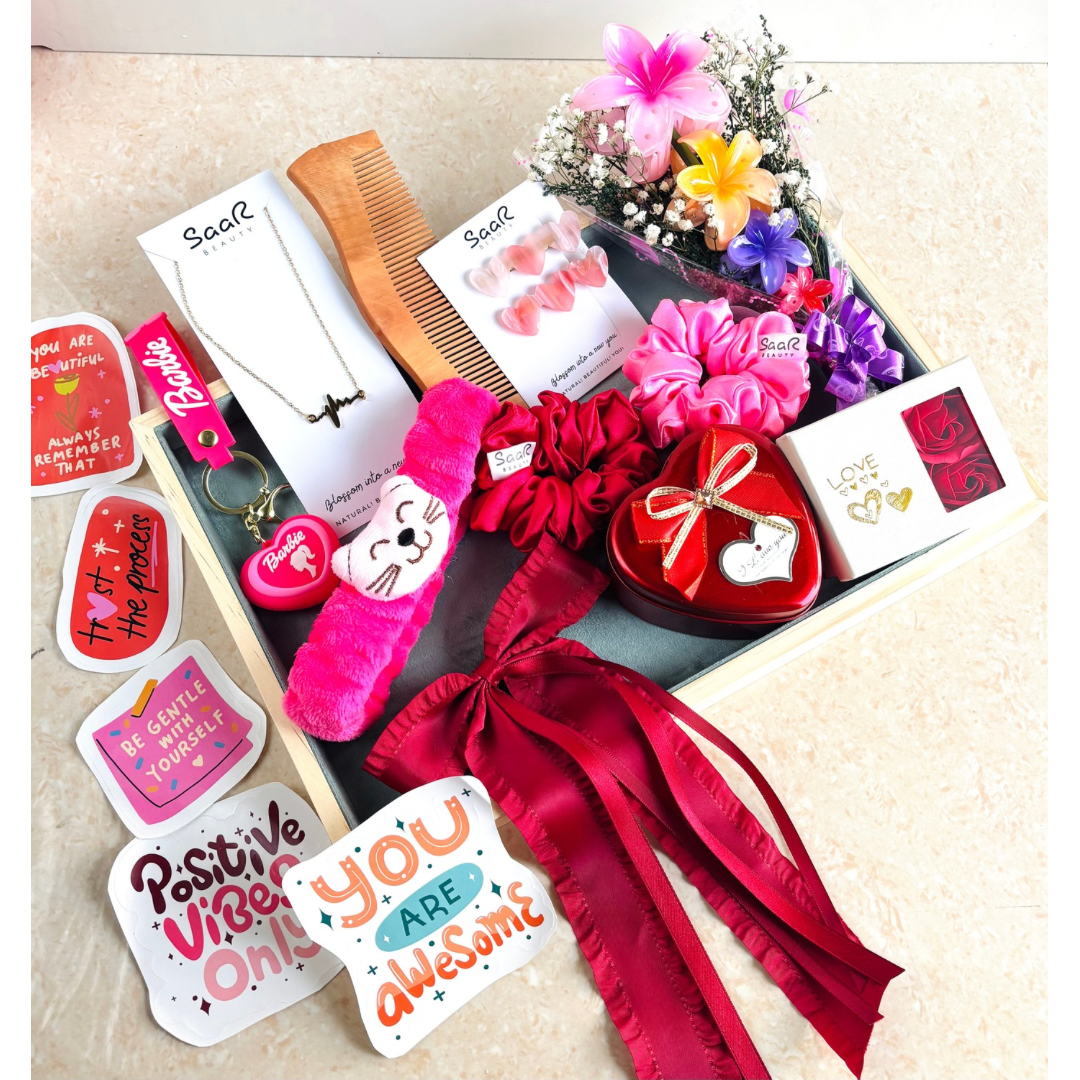 SaaR Beauty Valentine’s Gift Set – A luxury red-themed hamper featuring a necklace, earrings, floral hair clips, satin scrunchies, a keychain, stickers, and more.