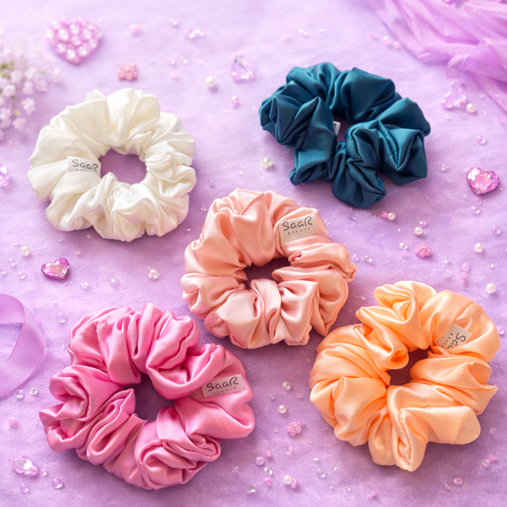 Set of five colorful scrunchies on a pink background Saar Beauty Japanese satin scrunchies set of 5 soft silk hair ties