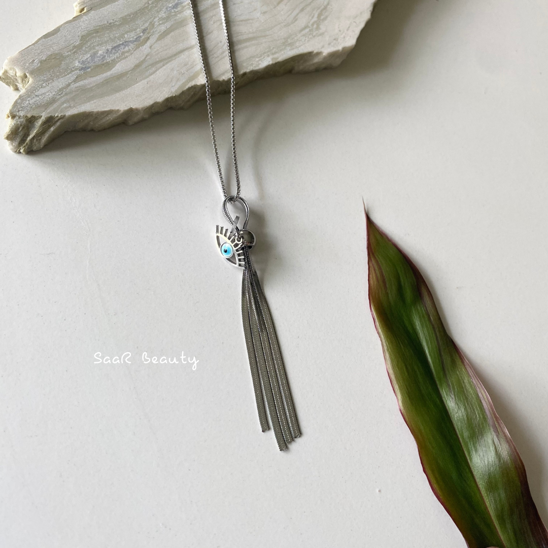 Metal chain necklace with a pendant in the shape of a EVIL EYE AND TESSEL&amp;nbsp; .&amp;nbsp;Adjustable length with a trigger clasp.  Accessory Style:&amp;nbsp;Pendant necklace Description: PROTECTING EVIL EYE NECKLACE WITH LASHES&amp;nbsp; Country of production:&amp;nbsp;India Common generic name:&amp;nbsp;Necklace Net Quantity:&amp;nbsp;1 N     Composition  Metal 80%, Polymethyl methacrylate 10%, Steel 10%