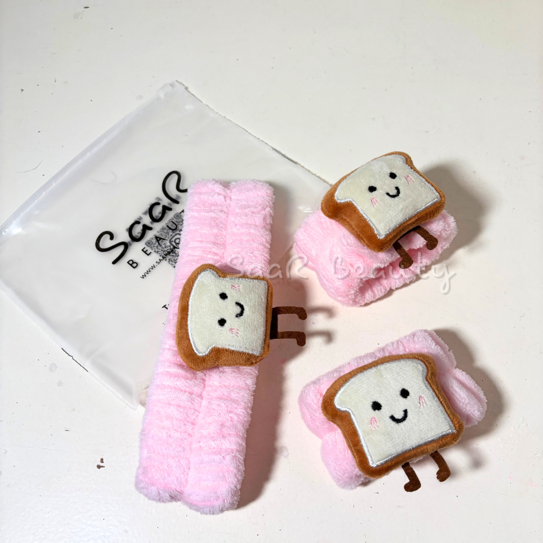 Plush toys shaped like cartoon toast with smiling faces on a white  Pink plush skincare headband with bread design and water-absorbing hand wrapsbackground