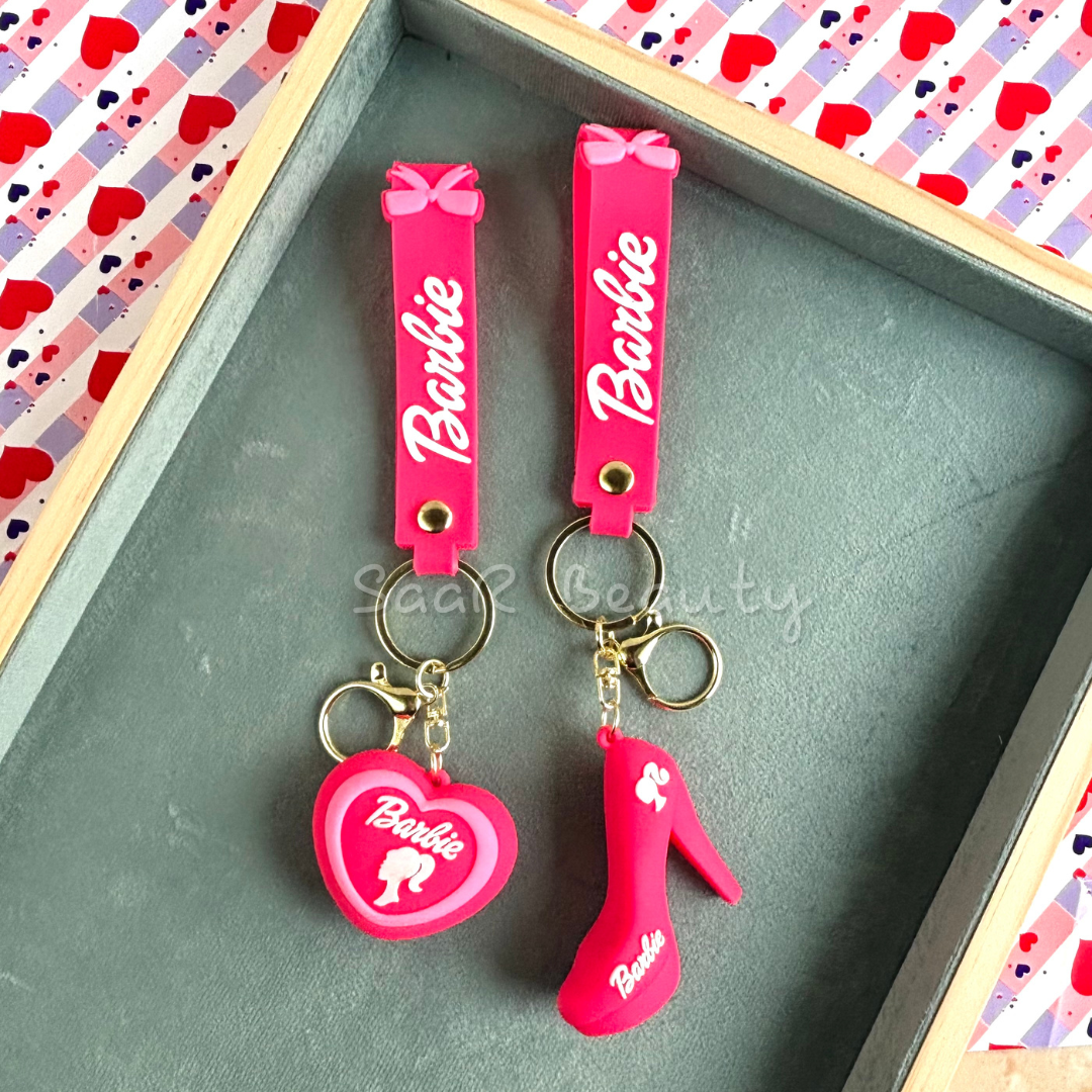 Stylish Barbie-themed silicone keychains in vibrant pink, featuring heart and high-heel charms, perfect for keys and accessories.