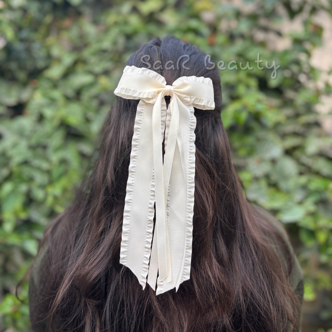 Discover the SaaR Beauty Long Bow Hair Clip, crafted in-house with premium satin material. Perfect for weddings, parties, or daily wear, this high-quality clip combines elegance, durability, and style. Shop now for a timeless accessory!