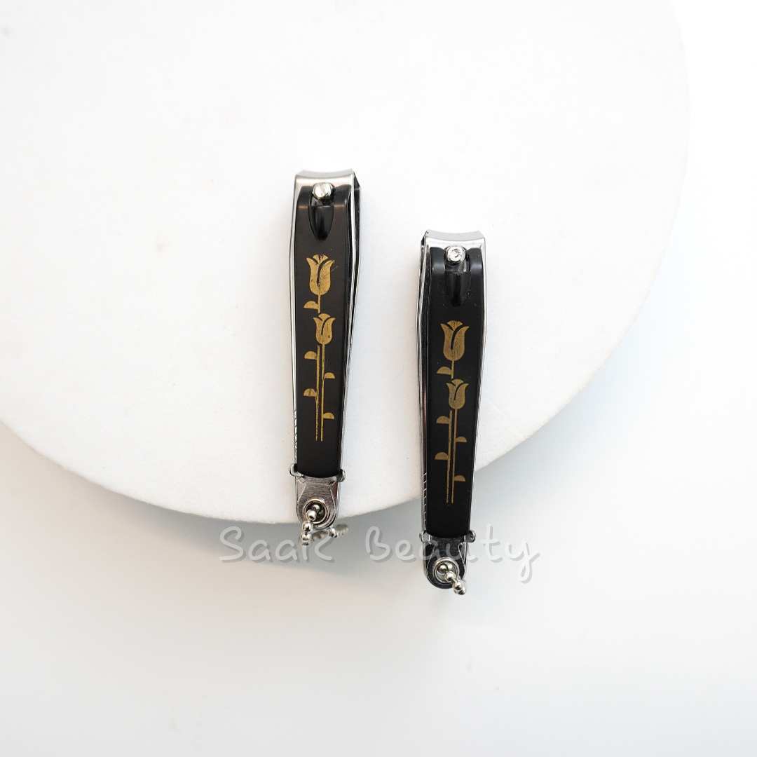 Black stainless steel nail clipper with filer and golden rose motif for precision grooming