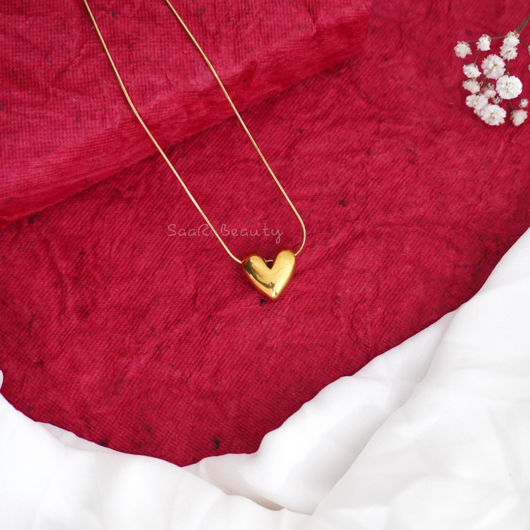 Gold heart pendant necklace by SaaR Beauty, featuring a sleek, minimalist design with anti-tarnish waterproof stainless steel and hypoallergenic properties.