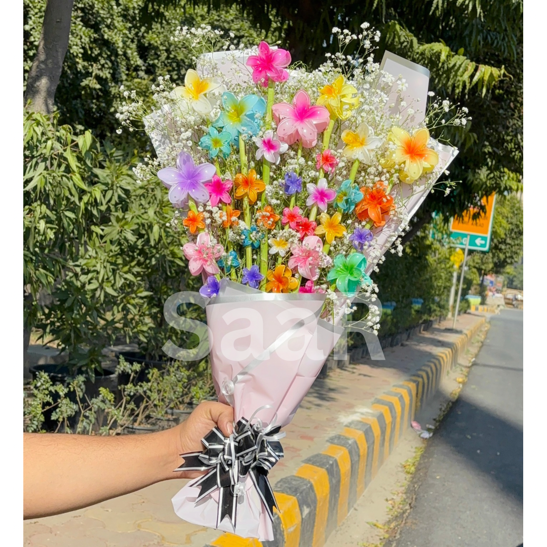 Luxury flower claw clip bouquet by SaaR Beauty, featuring 34 floral hair claw clips, 17 scrunchies, and 10 airtight pouches in elegant pink & black packaging. The perfect gift for hair accessory lovers, delivered pan India.