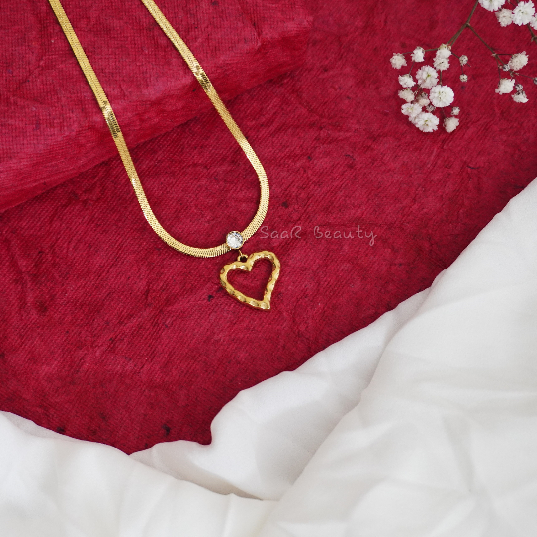 Gold heart pendant necklace with a herringbone chain by SaaR Beauty, crafted from durable waterproof stainless steel.