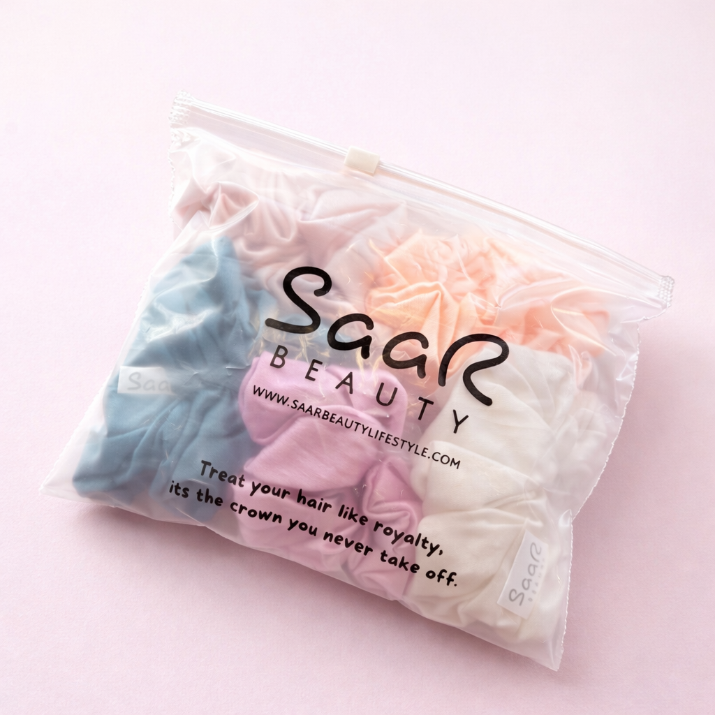 Packaged hair scrunchies from Saar Beauty on a pink background Saar Beauty Japanese satin scrunchies set of 5 soft silk hair ties