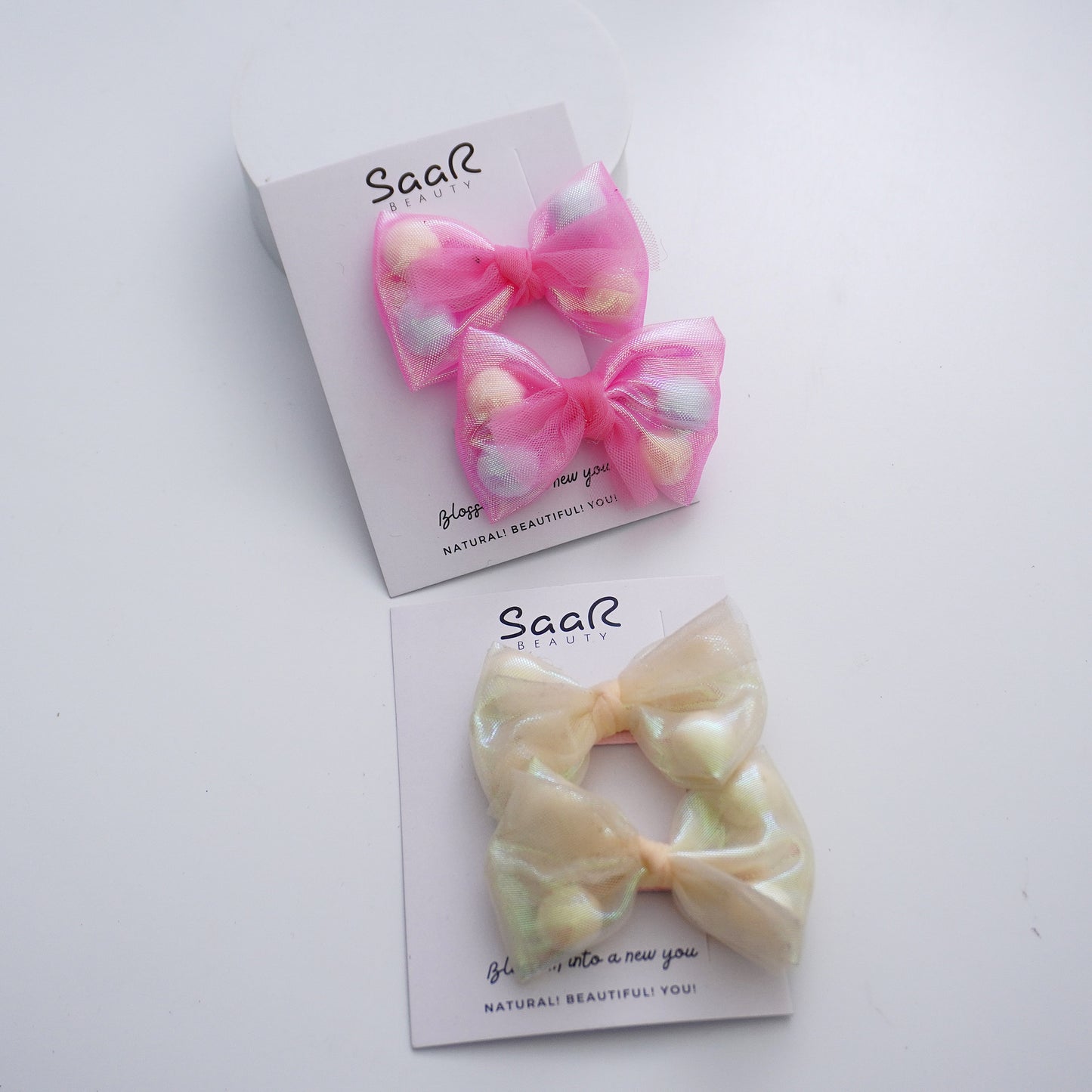 Add sparkle to your style with SaaR Beauty's Pom Pom Shiny Bow Hair Clip Set. High-quality, playful design, secure grip—perfect for any occasion. Trusted brand!