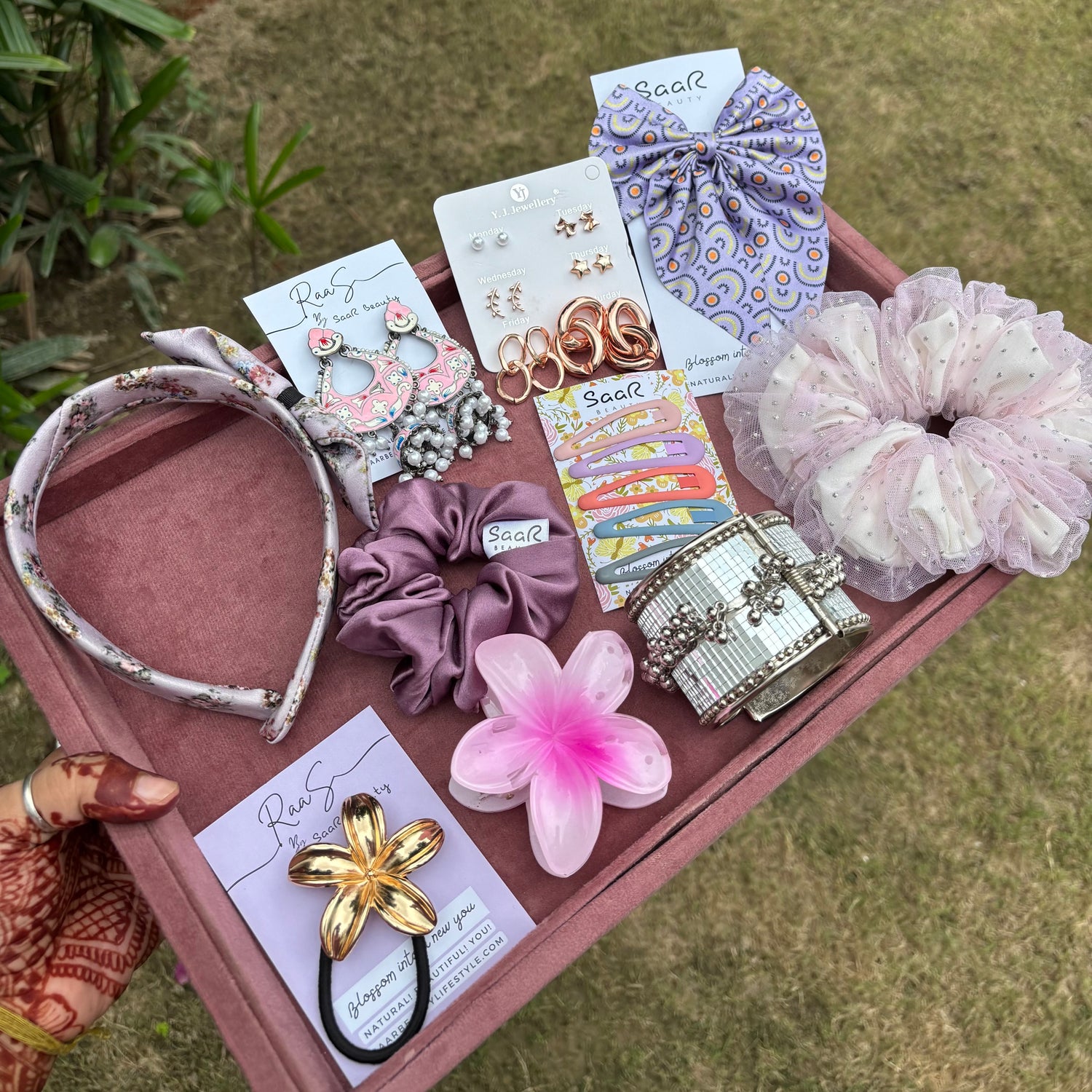 Rakshabandhan Gift Box with jhumka earrings, satin scrunchies, fluffy bow, floral claw clip, satin headband, kada bracelet, and tic tac clips by Saar Beauty.