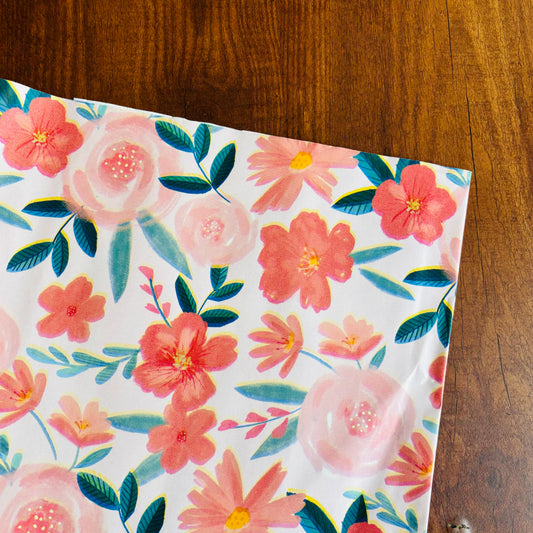 Floral-patterned paper on a wooden surface Romantic pink floral gift wrap with watercolor-style blooms and green leaves – perfect for weddings and spring gifts