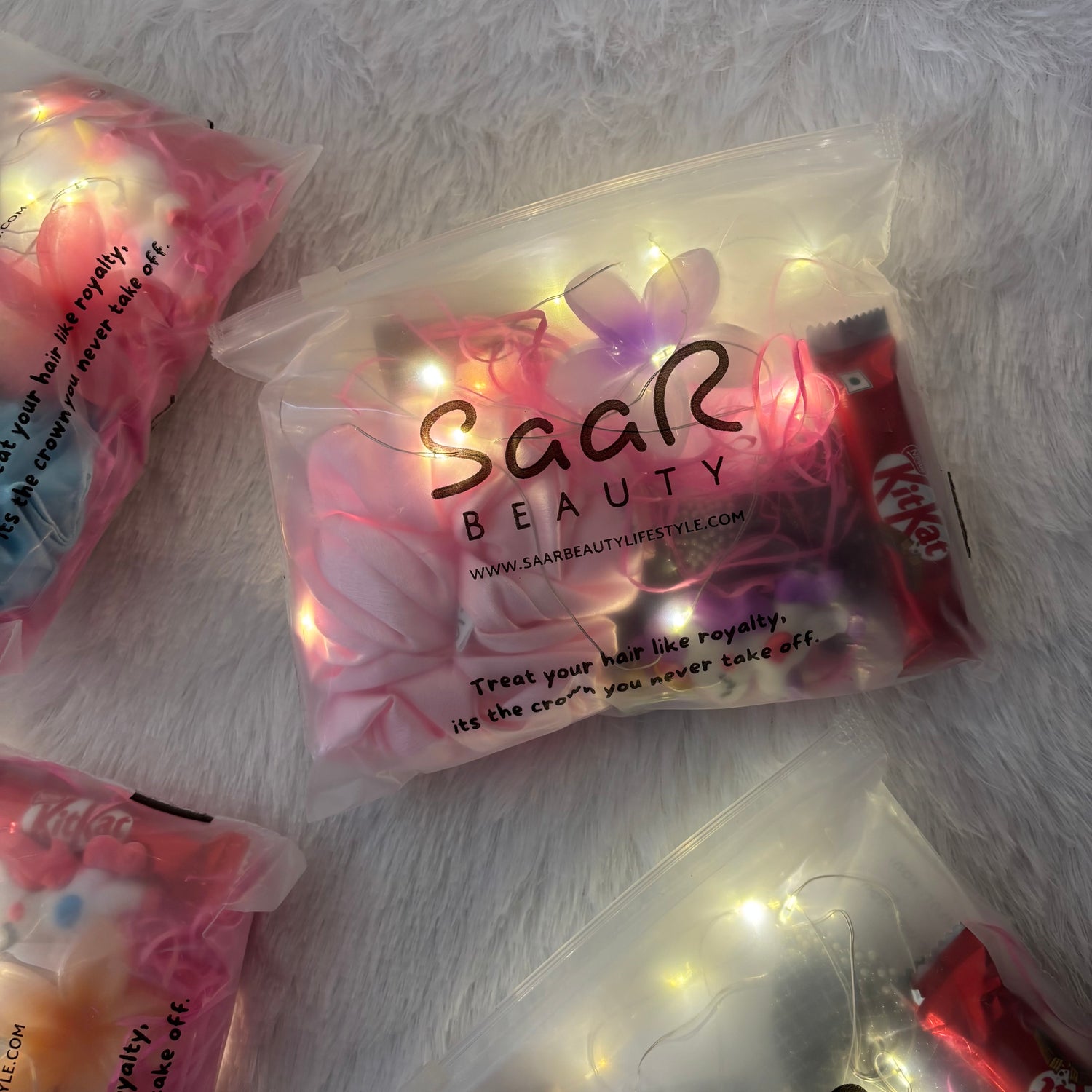 SaaR Beauty hair product packaging with KitKat candy on a white surface Pinterest aesthetic fairy light gift hamper Saar Beauty